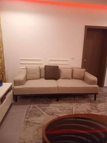 a living room with a couch in a room at Woodloft in Lagos