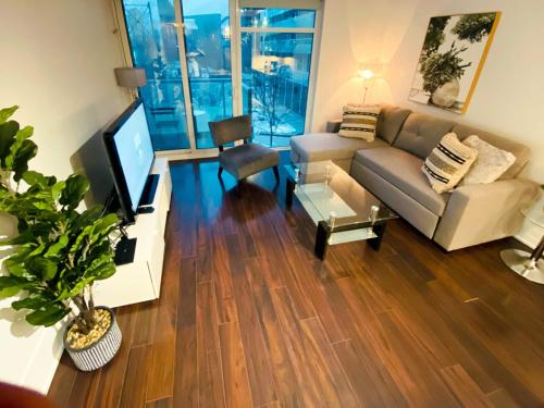 a living room with a couch and a television at Union Centre Hotel & Suites in Toronto