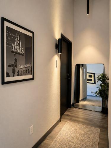 a hallway with a black door and a mirror at Boxstel - Modern Stay Hotel Downtown El Paso in El Paso