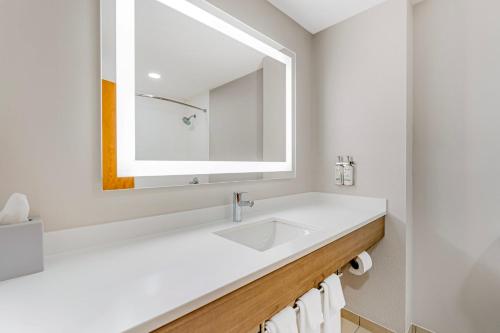 a white bathroom with a sink and a mirror at Holiday Inn Express Breezewood by IHG in Breezewood