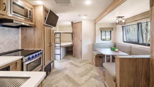 a kitchen and dining area of a caravan at Sokcho Supuro Caravan in Sokcho