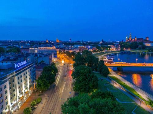 a view of a city at night at Novotel Kraków Centrum in Krakow
