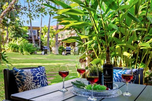 a table with wine glasses and a bottle of wine at Maui Sands 3C in Honokowai