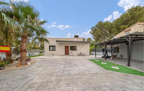 a house with a palm tree and a driveway at Villa Villaplana in Fortuna
