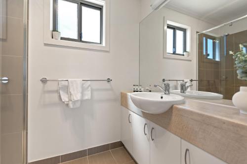 a white bathroom with a sink and a shower at Tasman Holiday Parks - Lake Mulwala in Mulwala