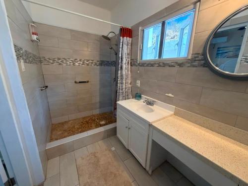 a bathroom with a sink and a shower at Sea-Renity in Philipsburg