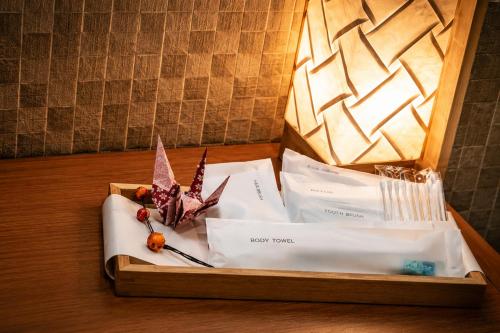 a table with a tray with a box of food items at kaguya asakusa Women only guest house in Tokyo