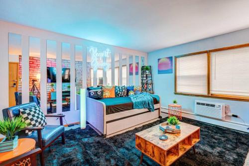 a room with a bed and a couch and a table at 90s Condo| King Bed | 65” Smart TV | Arcade Game in Elmwood Park