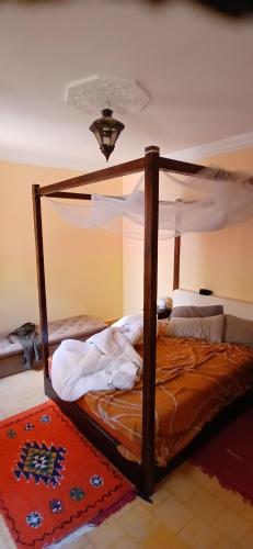 a bed with a canopy in a room at mirleft in Mirleft