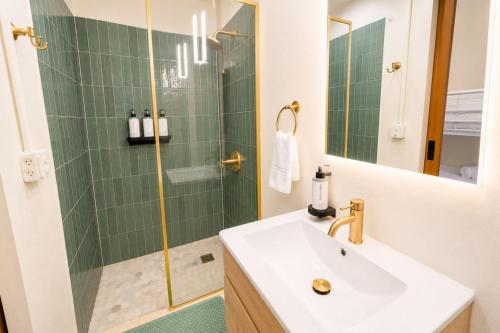 a bathroom with a sink and a shower at Room 4: Minimalist Bunk Room w/ Free Parking | San Juan in San Juan