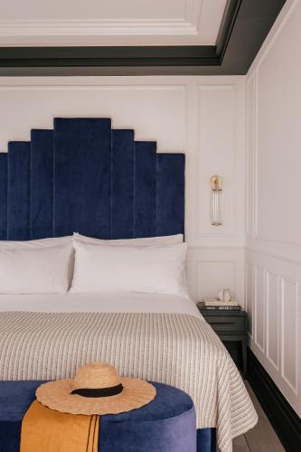 a bedroom with a large bed with a hat on it at MiM Ibiza member of Meliá Collection in Ibiza Town