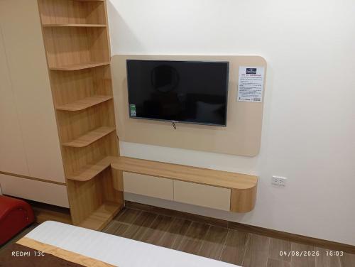 a tv on a wall in a room at Nam Thanh Hotel in Nhật Tựu