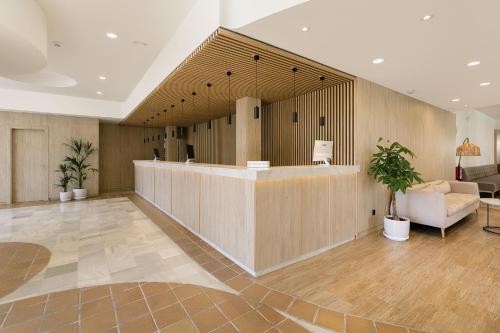 a lobby with a reception desk in a building at SOL by Meliá Sancti Petri in Chiclana de la Frontera