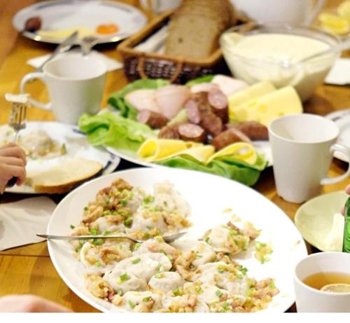 a wooden table with plates of food on it at Dylewianka in Wysoka Wieś