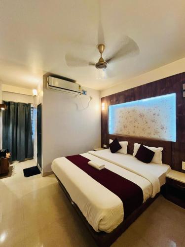 a bedroom with a large bed and a ceiling at HOTEL DAISY in Guwahati