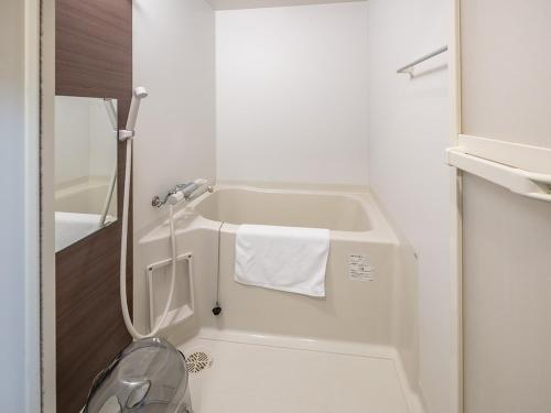 a small white bathroom with a toilet and a sink at Stay Maison Hida Takayama in Takayama