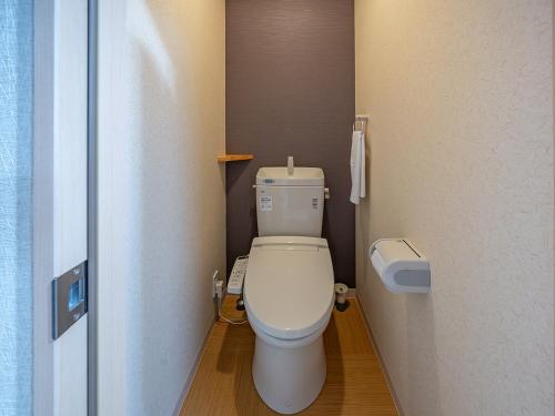 a bathroom with a white toilet in a room at Stay Maison Hida Takayama in Takayama