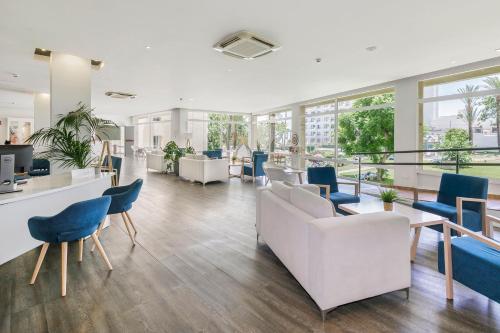 an office lobby with chairs and tables and windows at SOL by Meliá Puerto Marina in Torremolinos