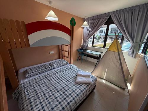 a bedroom with a bed with a checkerboard bedspread at Dino House in Taiping