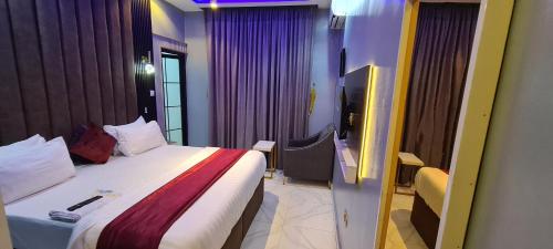 a hotel room with a bed and a window at Kiarra Suites Owerri in Owerri
