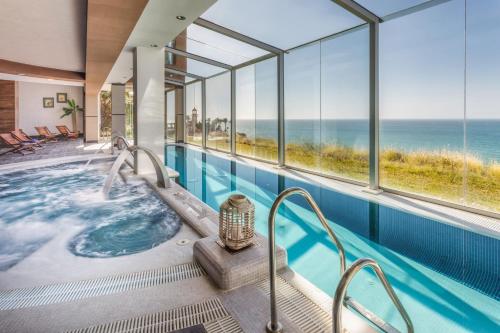 a hot tub with a view of the ocean at Holiday World Casamaïa Apartments, Affiliated by Meliá in Benalmádena