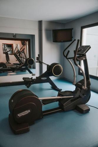a gym with two exercise bikes in a room at Palacio de Avilés, Affiliated by Meliá in Avilés