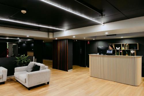 a lobby with a white chair and a counter at Punthill Spring Hill in Brisbane
