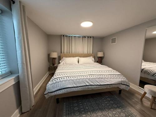 a bedroom with a large bed and a mirror at Private lux lower level flat fully fenced in Twin Falls