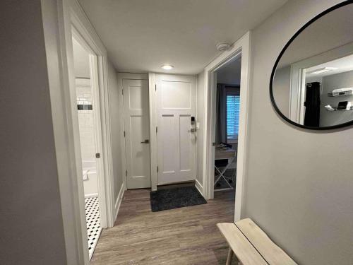 a hallway with a mirror and a hallway with a door at Private lux lower level flat fully fenced in Twin Falls