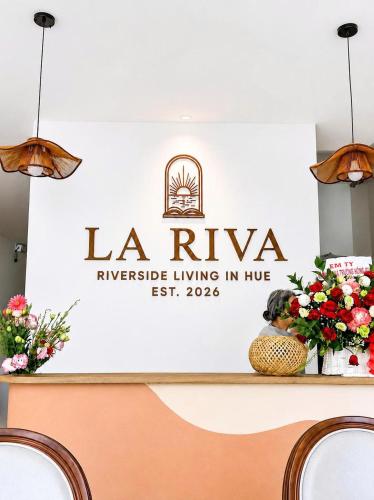 a sign for la rivaea riverside living in hilo at La Riva Riverside Hue Hotel & Rooftop in Hue
