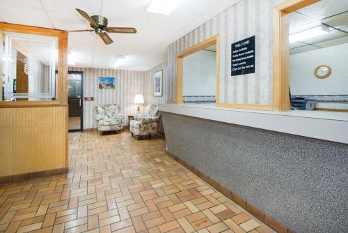 a lobby with a reception desk and a waiting room at Super 8 by Wyndham Nevada in Nevada