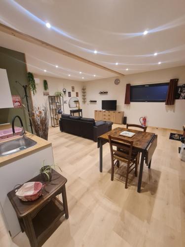 a living room with a table and a couch at Tiny House - Studio in Eygurande-et-Gardedeuil