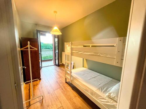 a small room with a bunk bed in it at Nice villa with pool and garden in Fermignano