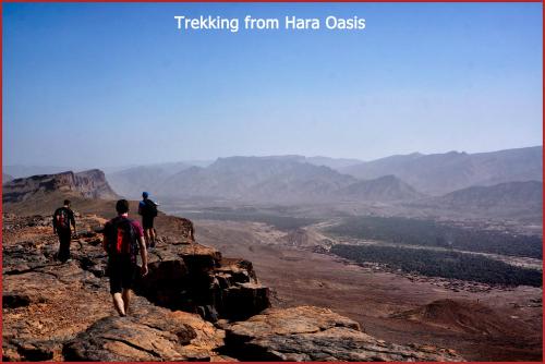 a group of people walking on top of a mountain at Lodge Hara Oasis in Agdz