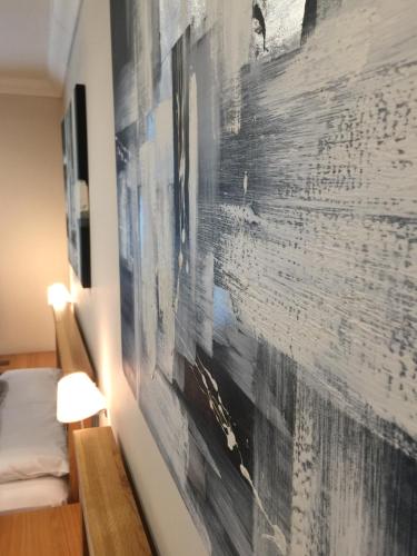 a painting hanging on a wall in a room at Barncroft Luxury Bed & Breakfast in Solihull