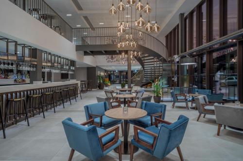 a restaurant with tables and chairs and a chandelier at INNSiDE by Meliá Newcastle in Newcastle upon Tyne