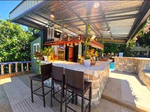 a patio with a table and chairs under a pergola at FFG Eden Private Resort in Basdiot
