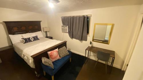 a bedroom with a bed and a mirror and a chair at Tree bedrooms in Salt Lake City