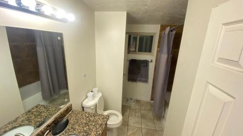 a bathroom with a toilet and a sink at Tree bedrooms in Salt Lake City