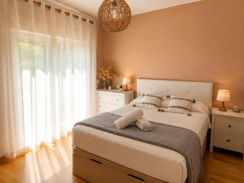 a bedroom with a large bed and a large window at Piso acogedor con terraza in Ciudad Real