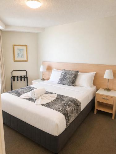 a hotel room with two beds and two lamps at Landmark Resort Mooloolaba 4th Floor Apartment with a View in Mooloolaba
