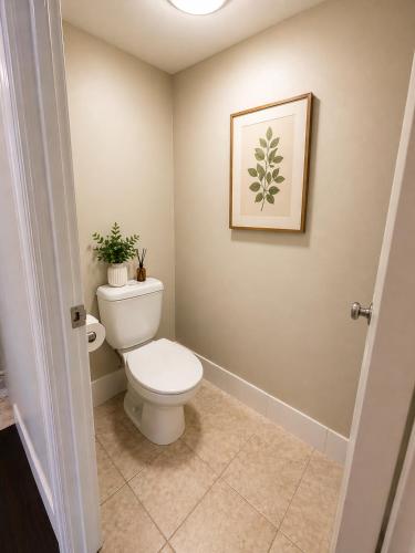 a bathroom with a toilet and a picture on the wall at Landmark Resort Mooloolaba 4th Floor Apartment with a View in Mooloolaba