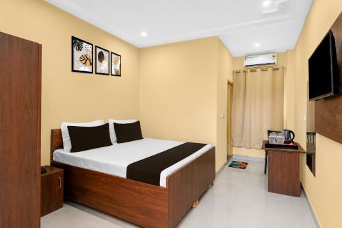 a bedroom with a bed and a television in it at Townhouse Defence Colony Noida in Greater Noida