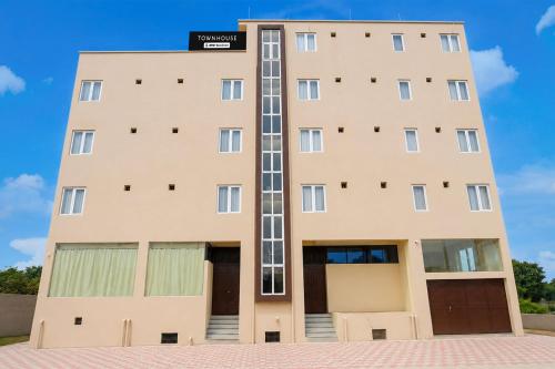a tall building with its doors open at Townhouse Defence Colony Noida in Greater Noida