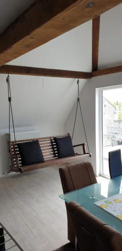a room with a table and chairs and a bed at Historic Canal-Side Apartment in Schiedam
