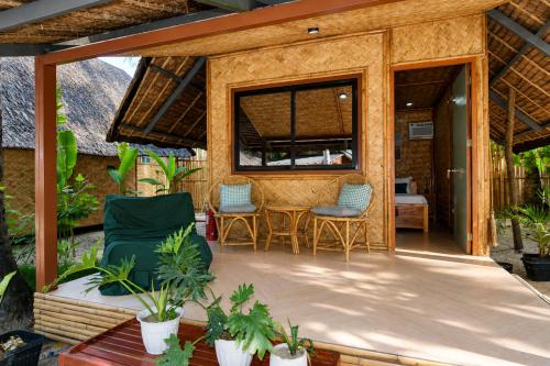 a screened in porch with chairs and a table at Sirem Beach Resort in Puerto Princesa City