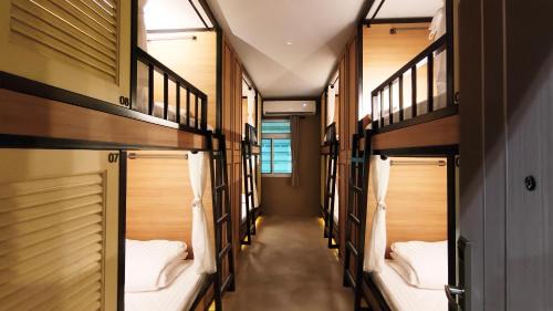 a row of bunk beds in a room at Kosin House in Bangkok