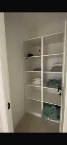 a closet with white shelves in a room at Panoramic view in Tamga