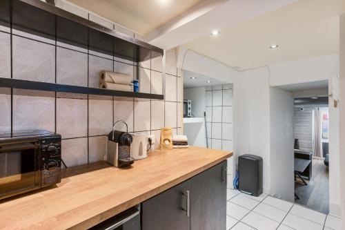 a kitchen with a wooden counter top in a room at Le Loft 11 Draguignan in Draguignan