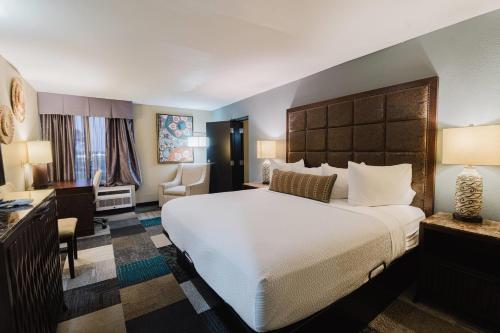 a hotel room with a large bed and a desk at Wyndham Garden Texarkana in Texarkana